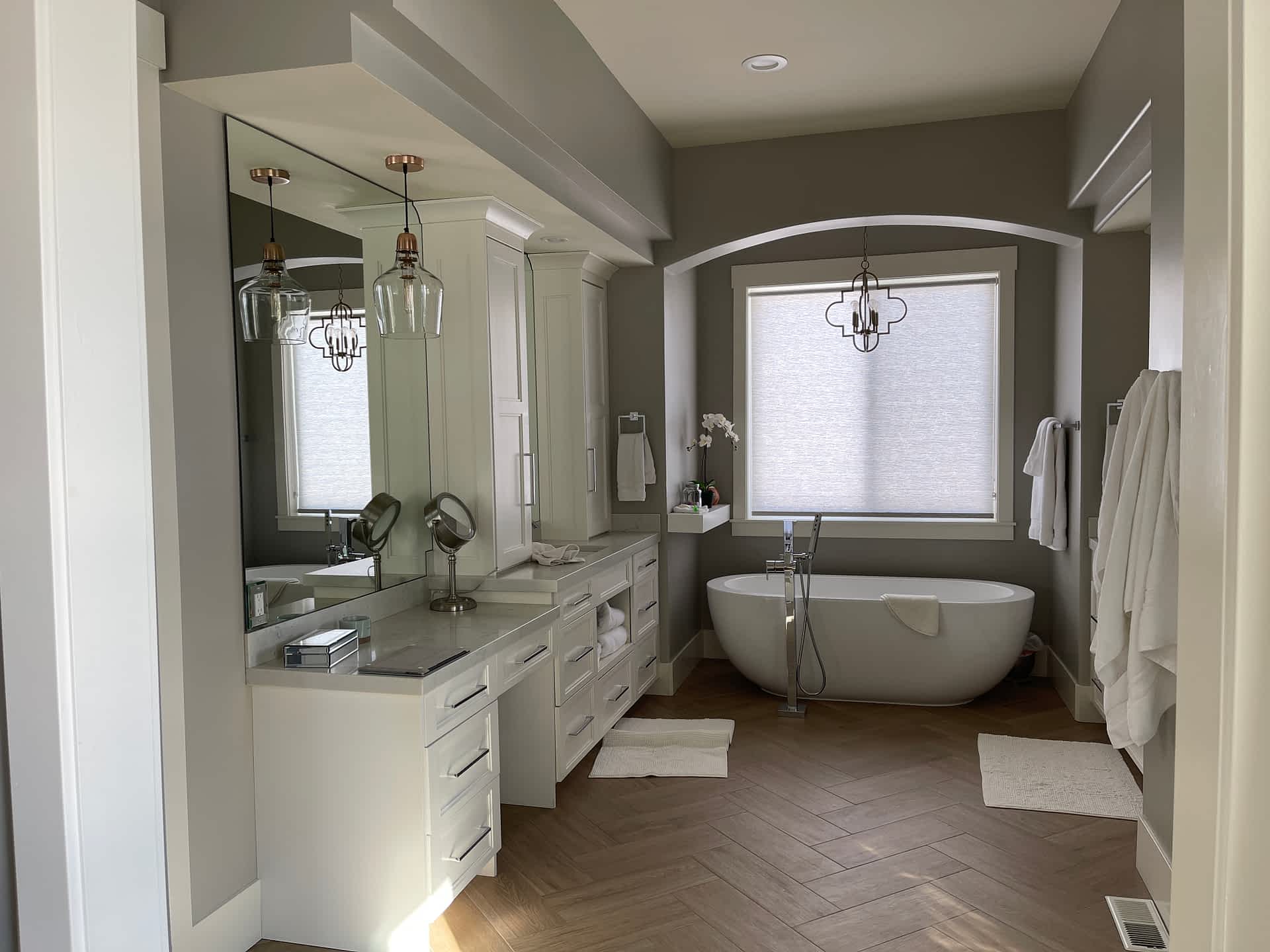 Bathroom with freestanding tub and painted cabinetry