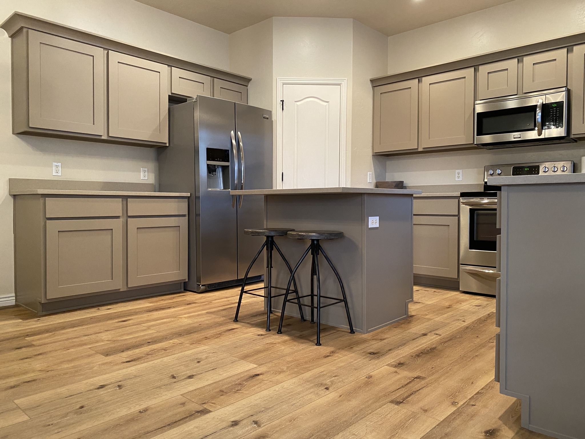 Gray cabinet doors and a dark kitchen island
