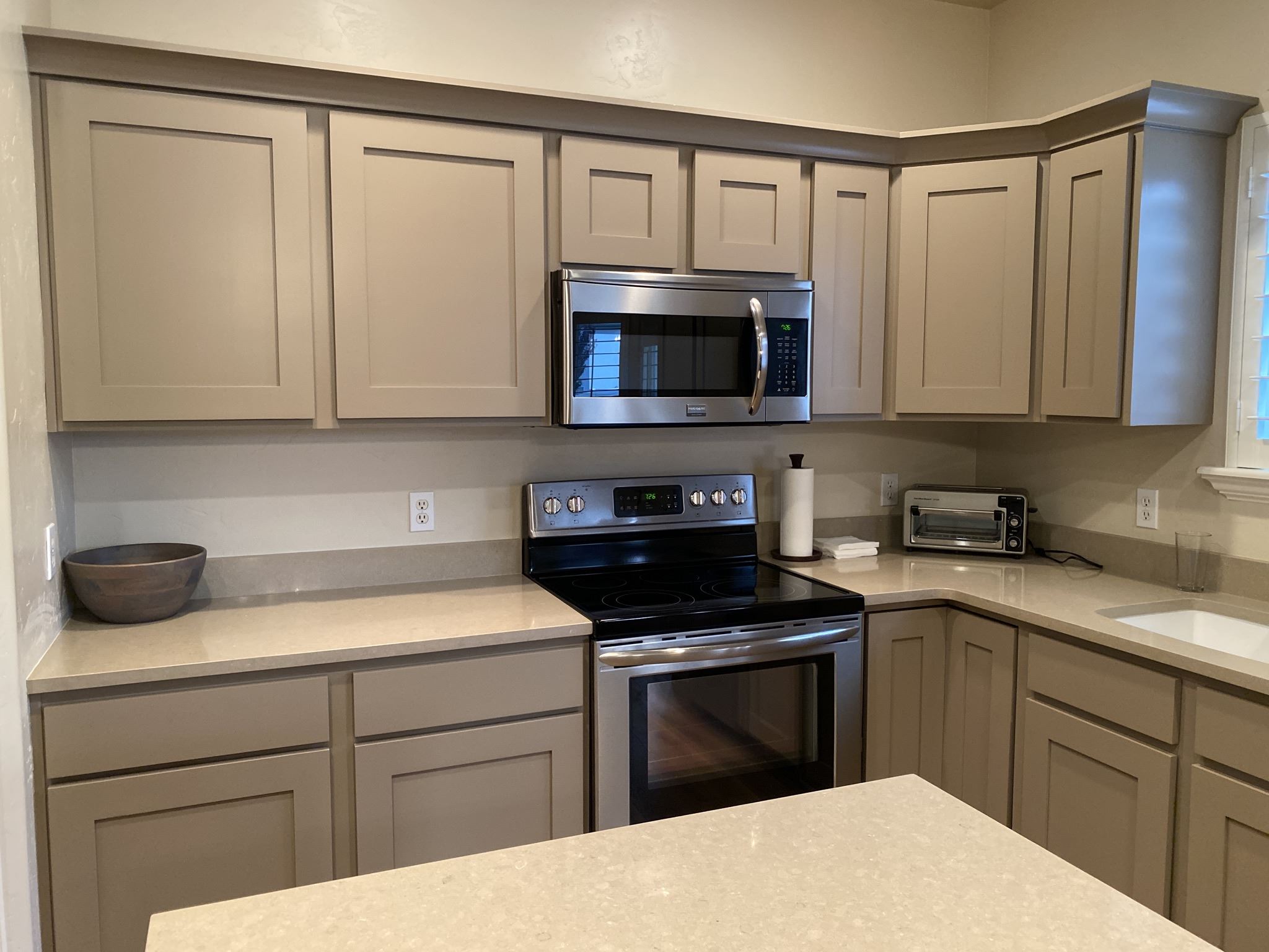 Gray kitchen cabinets with stainless steel appliances