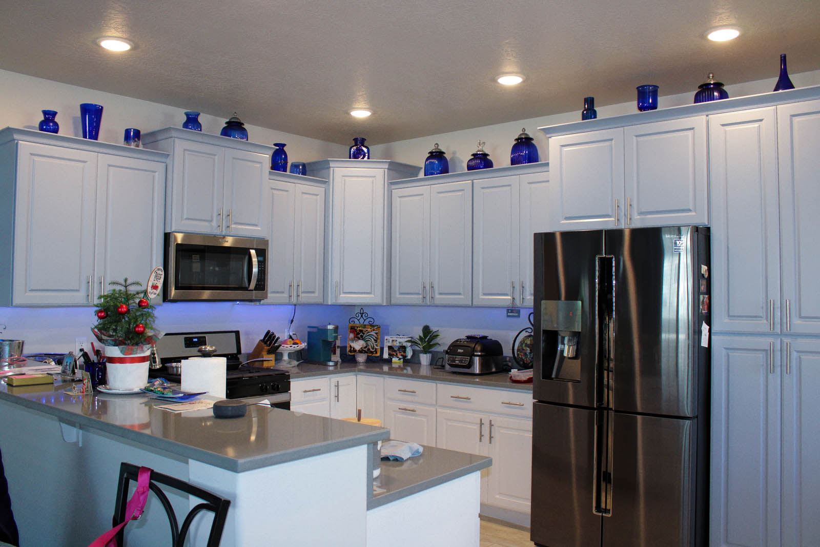 Kitchen with white cabinets and dark counters