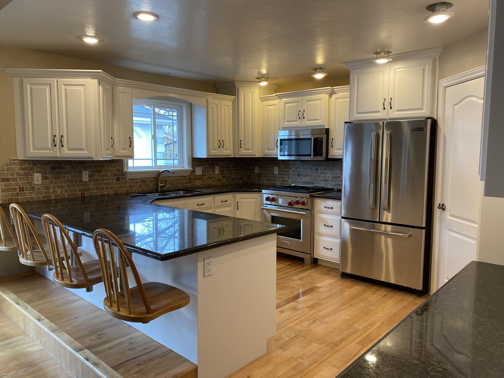 White cabinets and a blue island in a kitchen