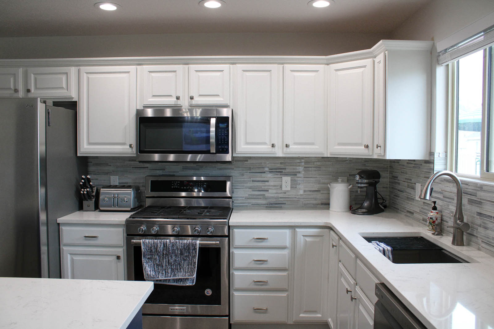 White cabinets and gray subway-tile backsplash