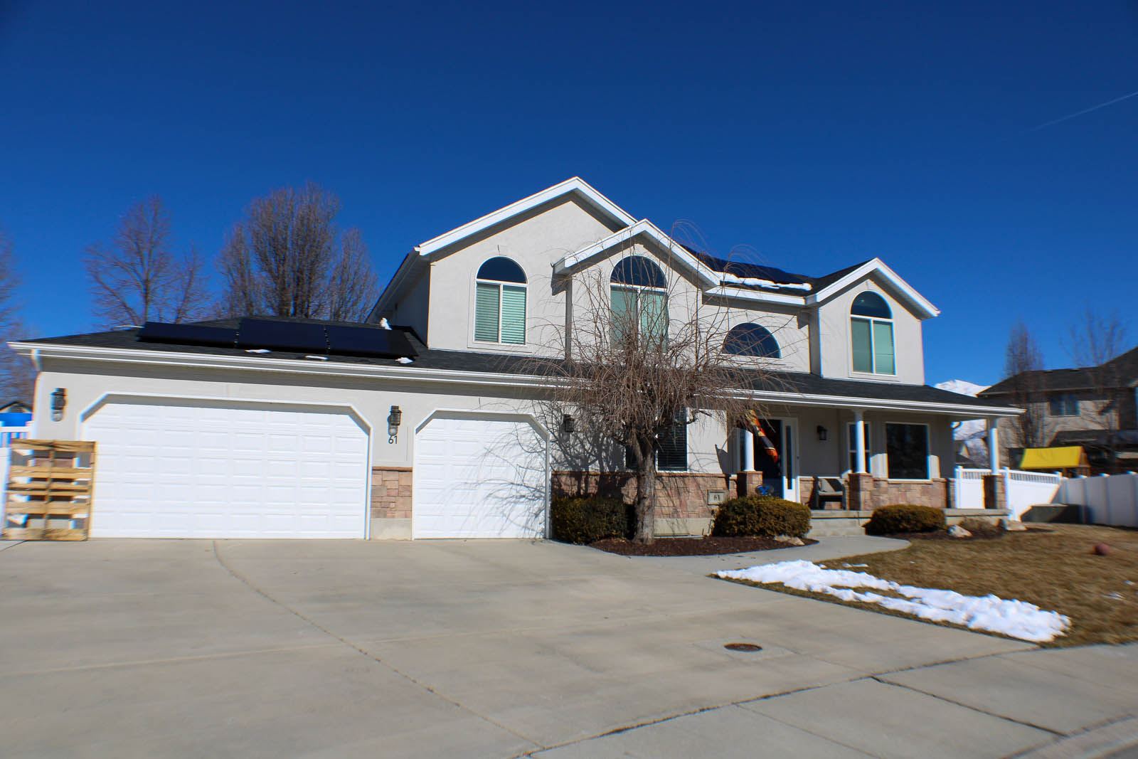 Two-story home exterior with stone and stucco