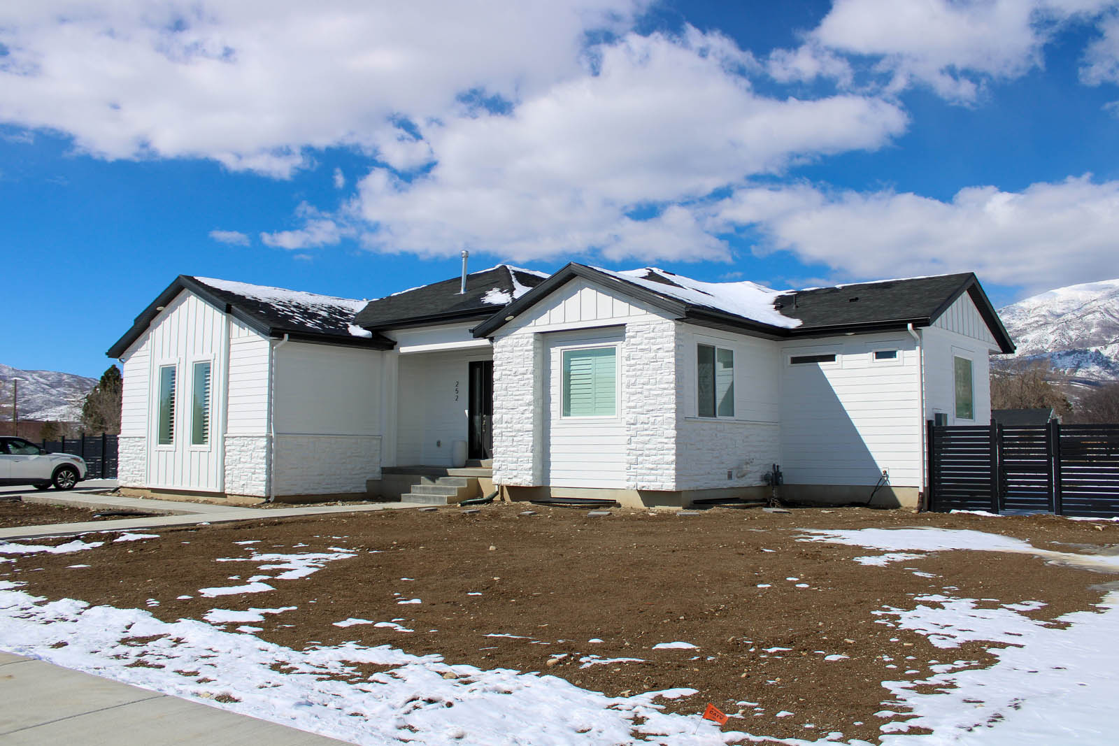 White home exterior with dark window trim