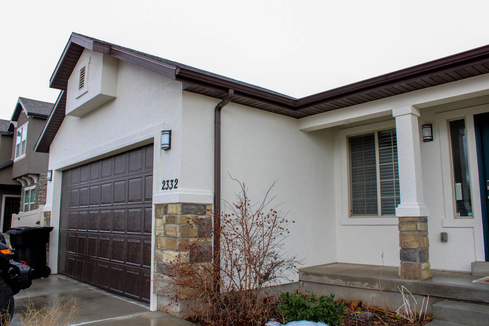 White house facade with stone and garage