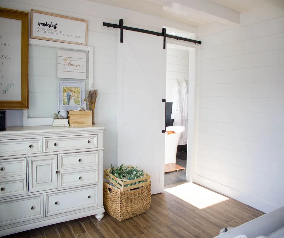 Bedroom with blue walls and white trim