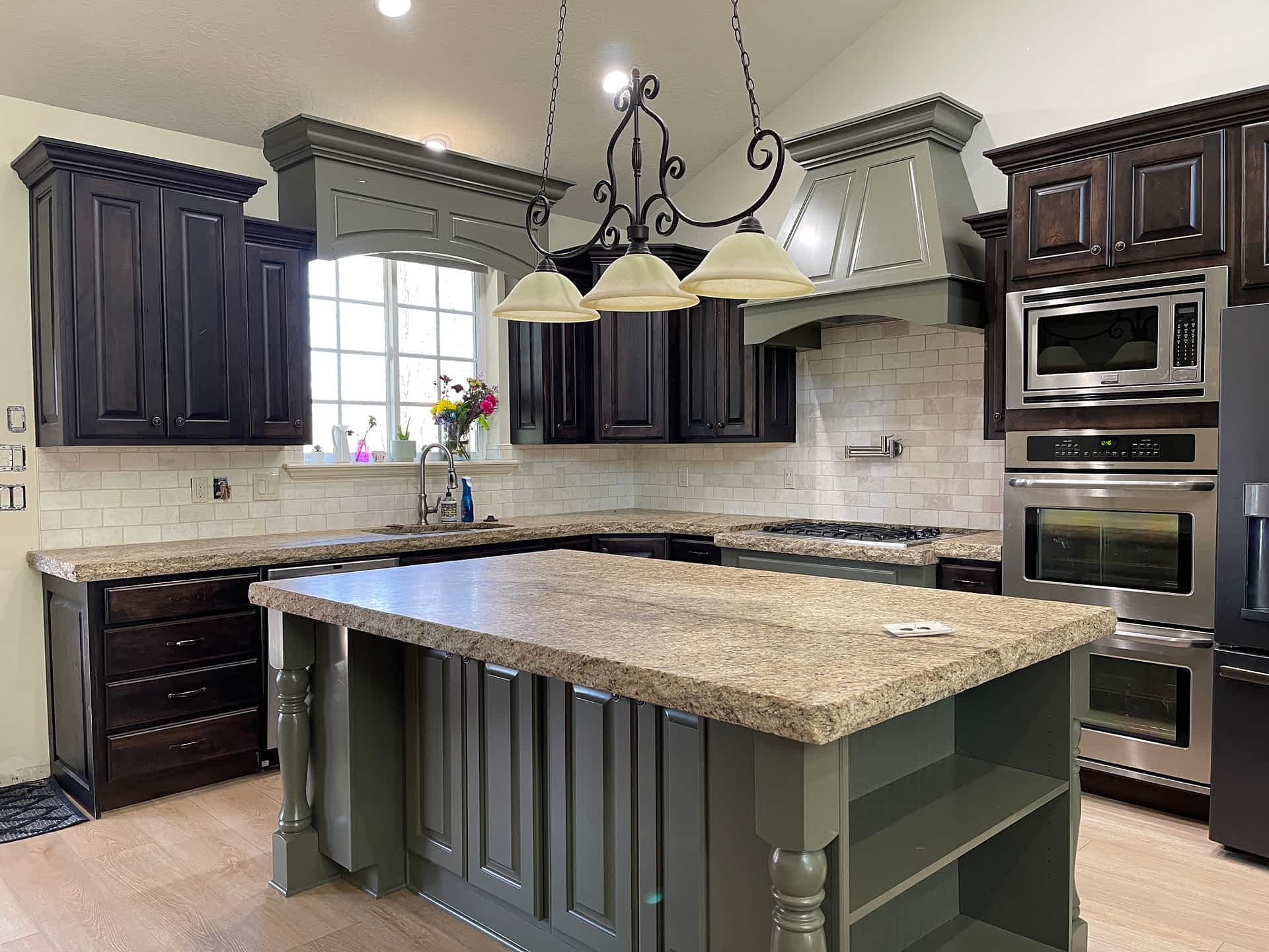 Kitchen with dark cabinets and a pale island