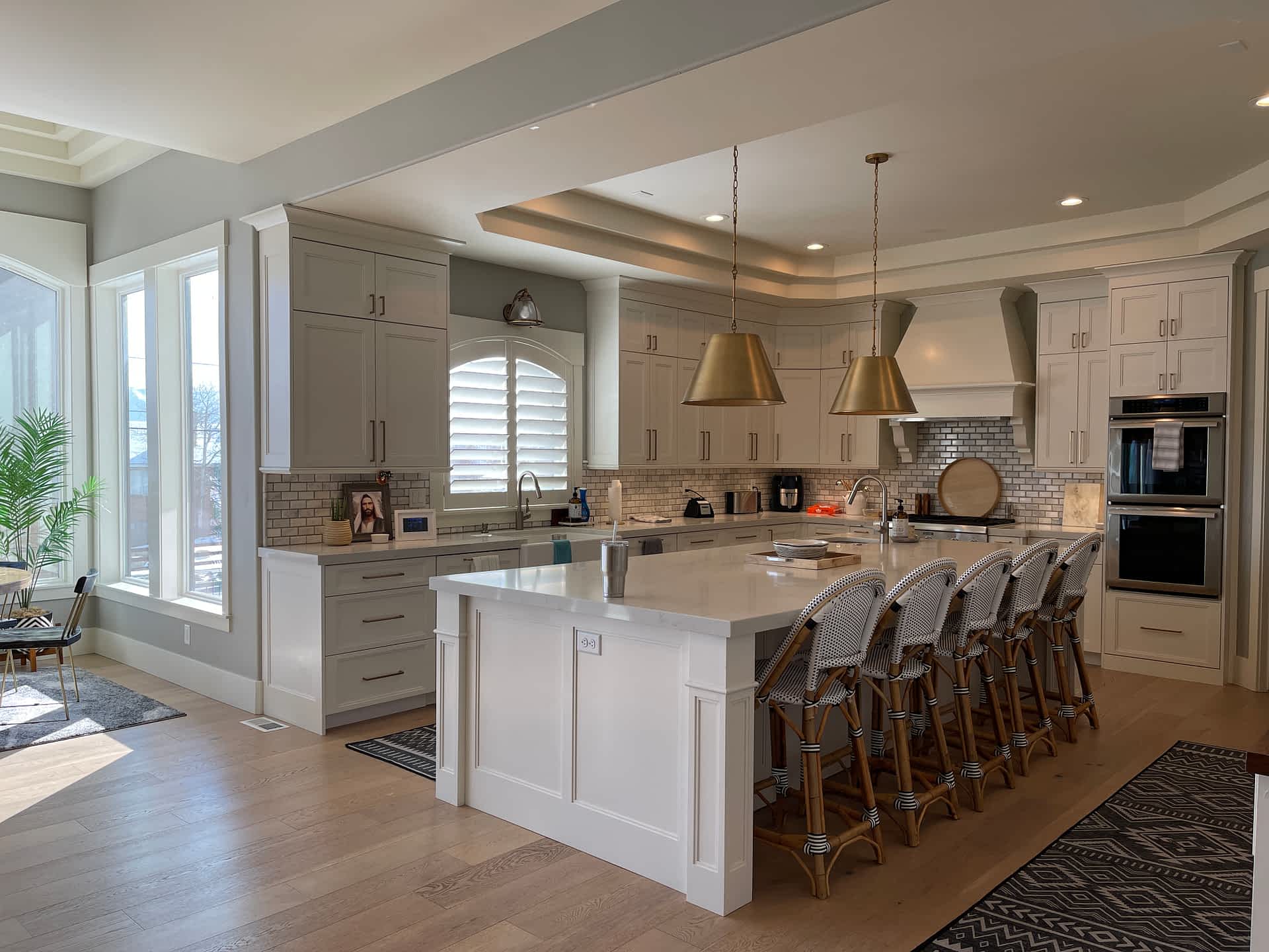 Kitchen with white perimeter cabinets and dark island
